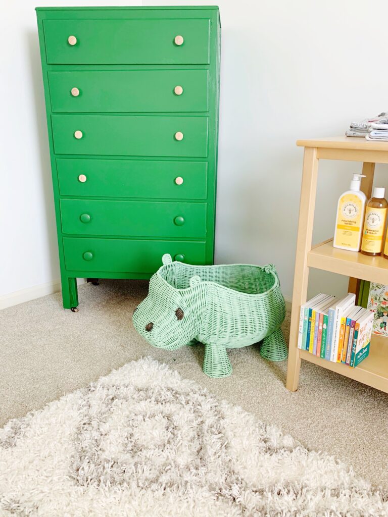 green dresser in corner of nursery