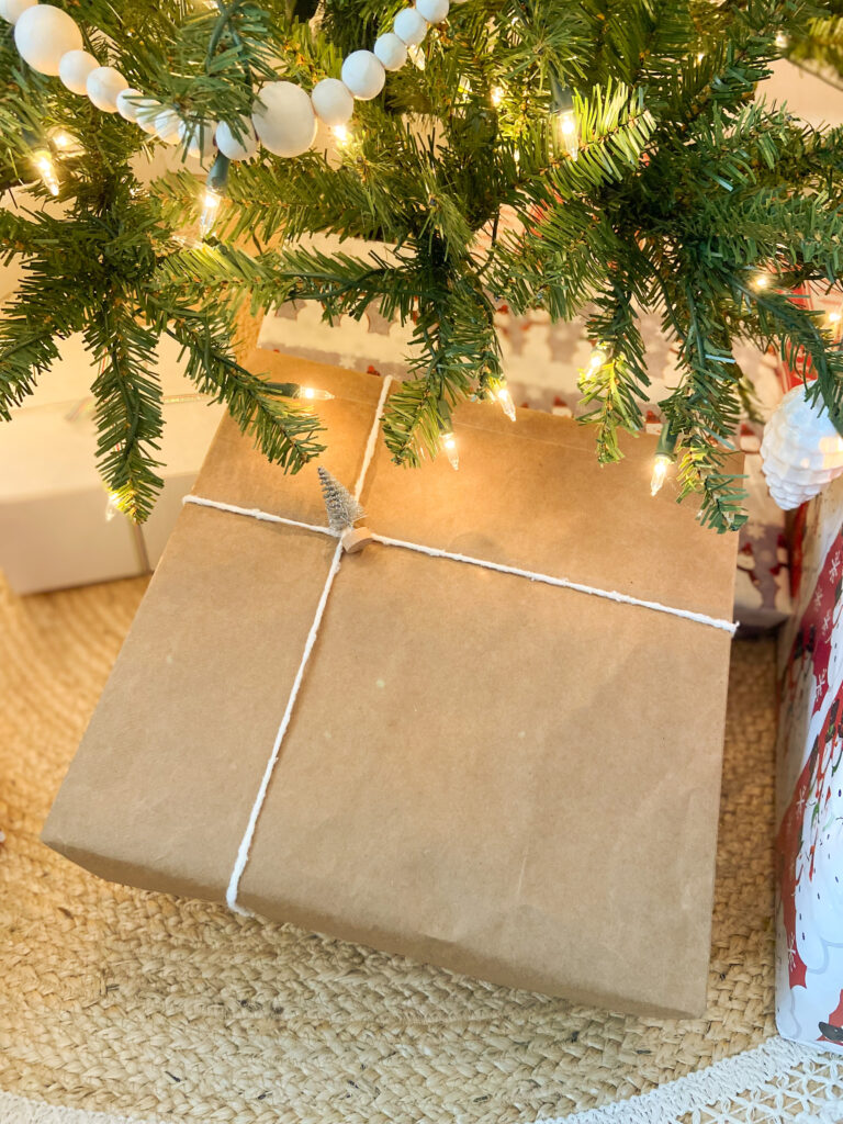 using bottle brush tree on package under a Christmas tree
