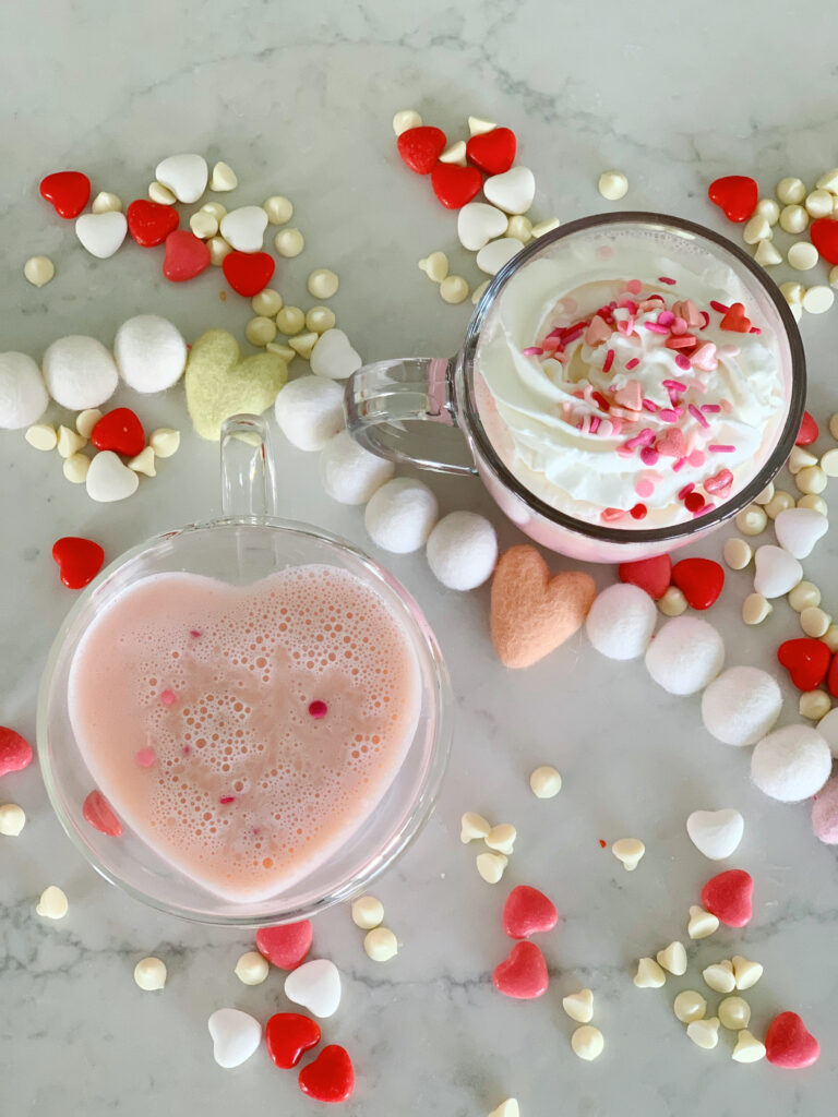 overhead shot of two glasses of pink hot chocolate