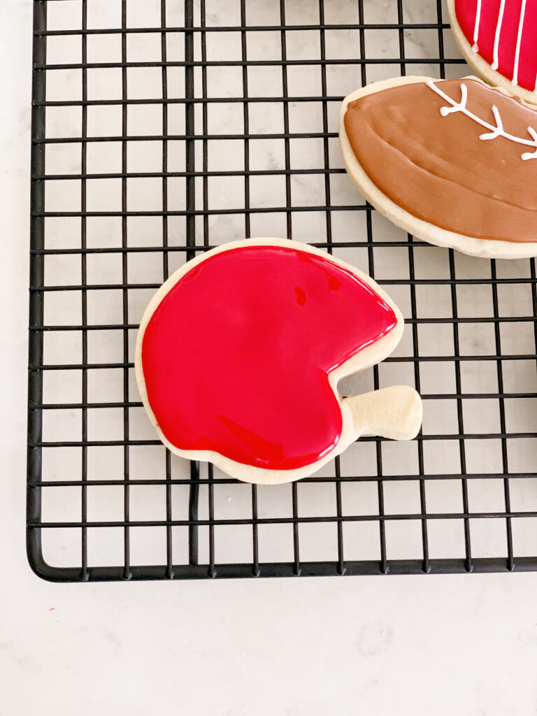 cookie with red icing flood on tray.