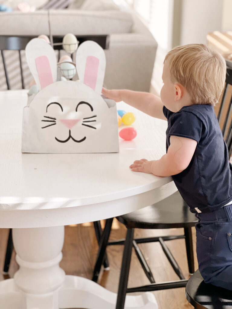 child reaching for bunny basket