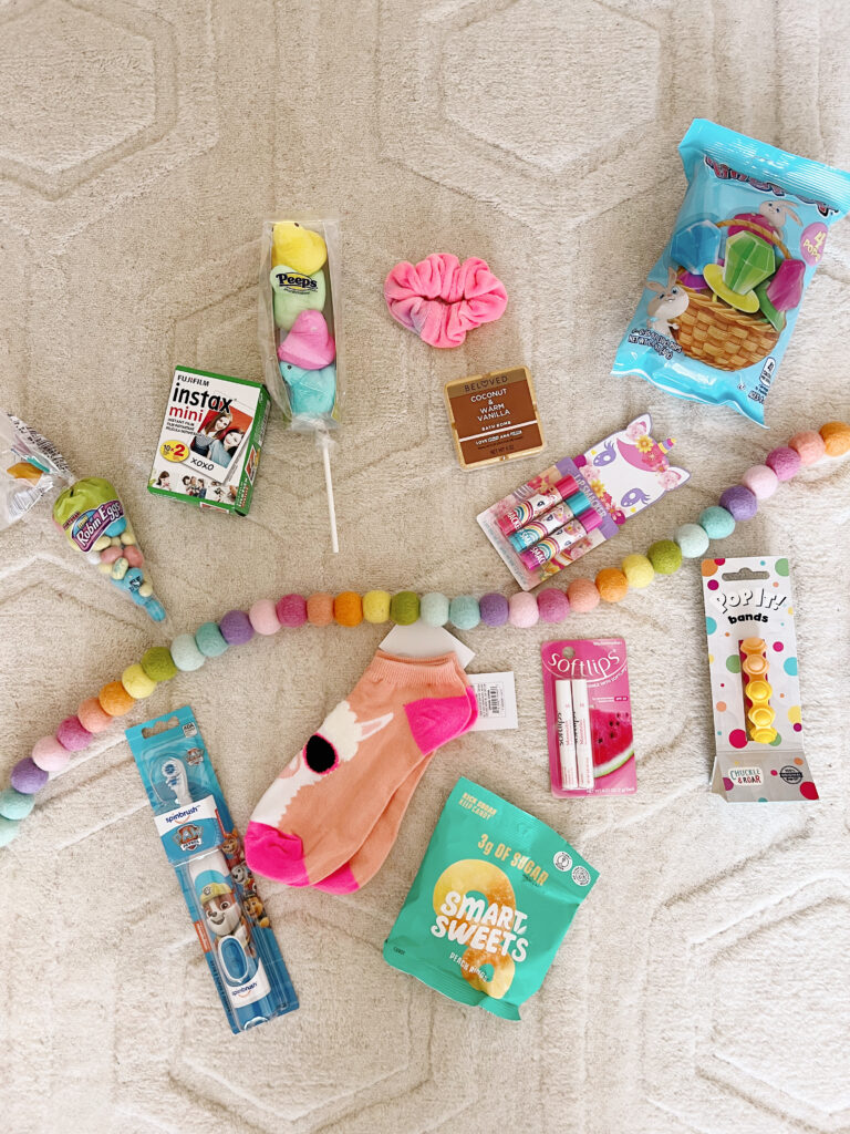 Easter basket goodies including candy, socks, lipgloss and toothbrush