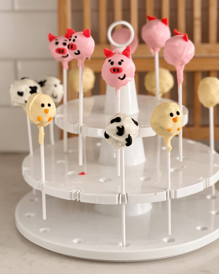 cake pops in a cake pop stand on counter.