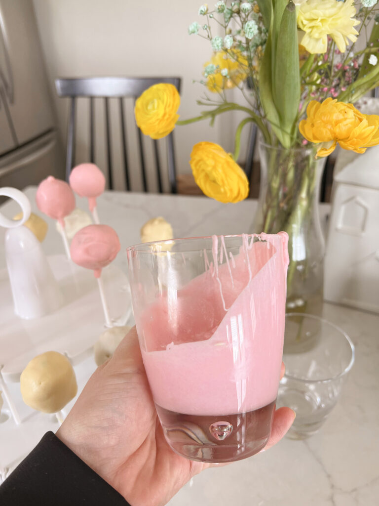 glass with pink melted chocolate inside.