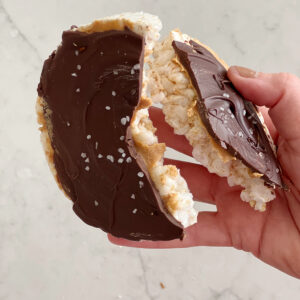 rice cake with peanut butter and chocolate broken in half.