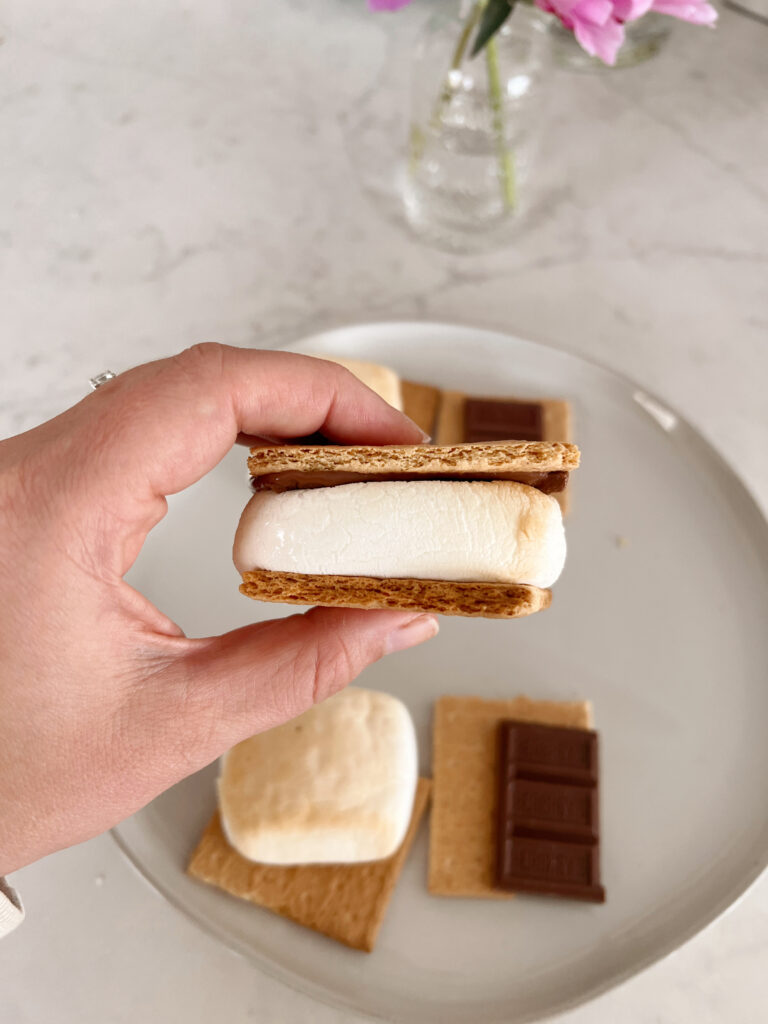woman holding a s'more.