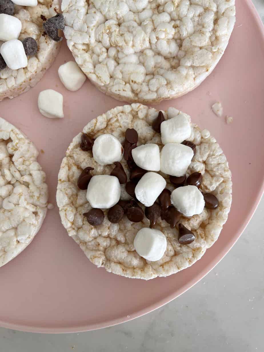 rice cake on plate with chocolate chips and mini marshmallows