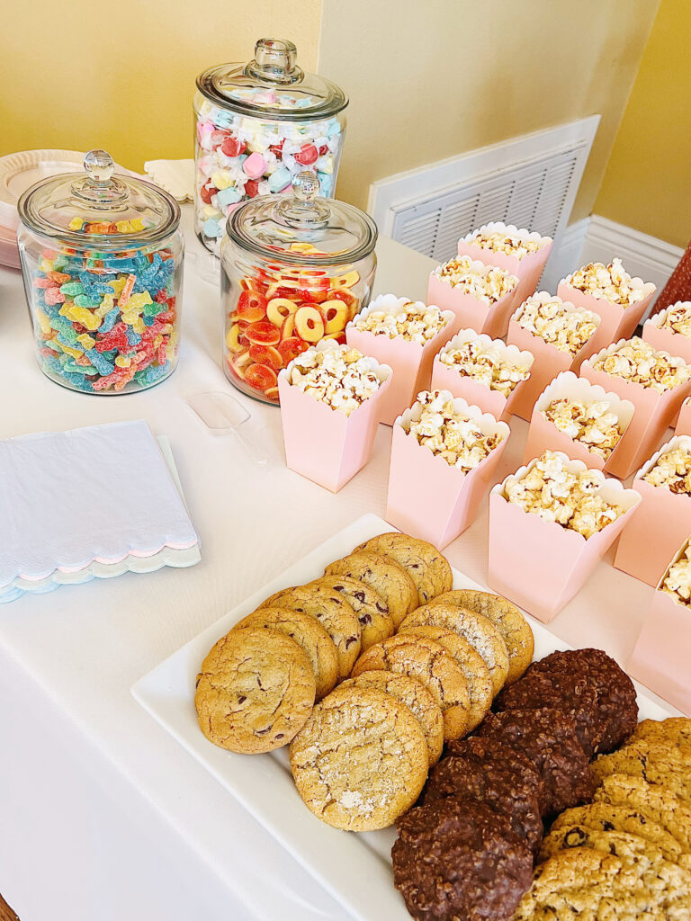 table with candy and kettle corn on it.