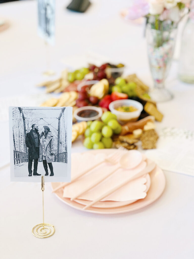 photo of a couple on a table with place setting. 