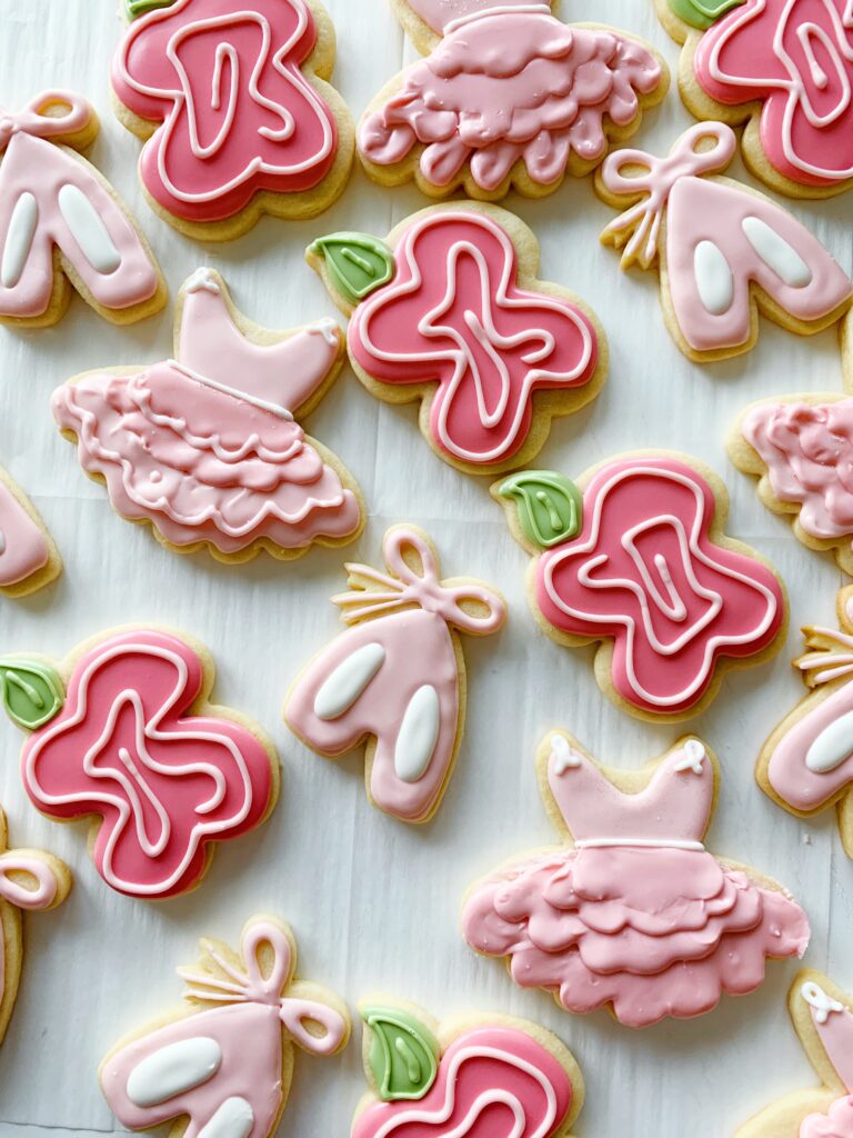sugar cookies shaped in tutus, flowers and ballet slippers.