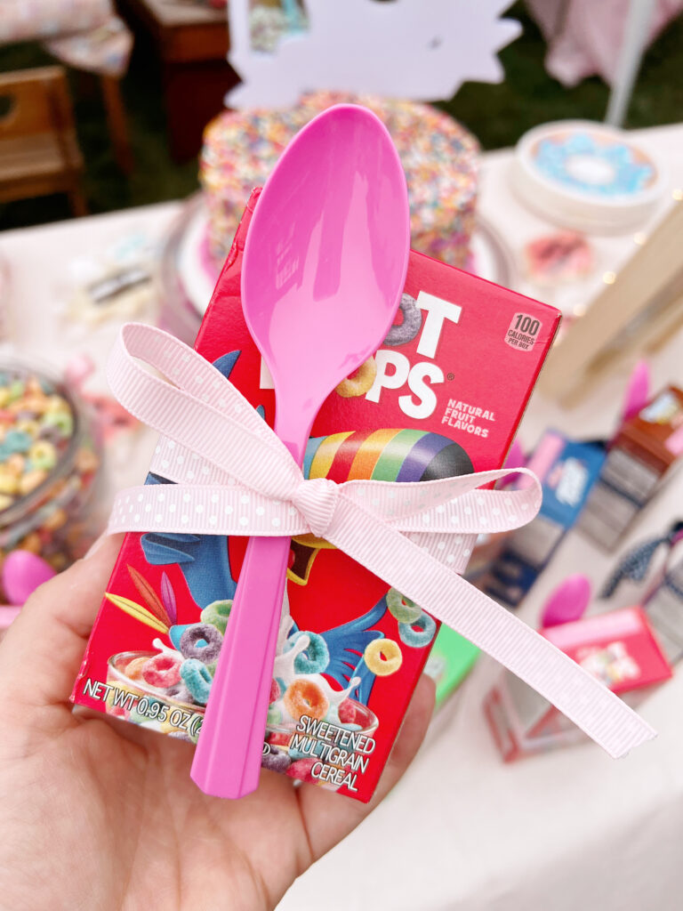 Fruit loops box with a spoon tied together with a ribbon. 