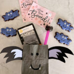 paper bag painted to look like a bat with cookies and treats.