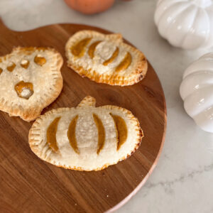 hand pies in shape of pumpkin on a serving tray.