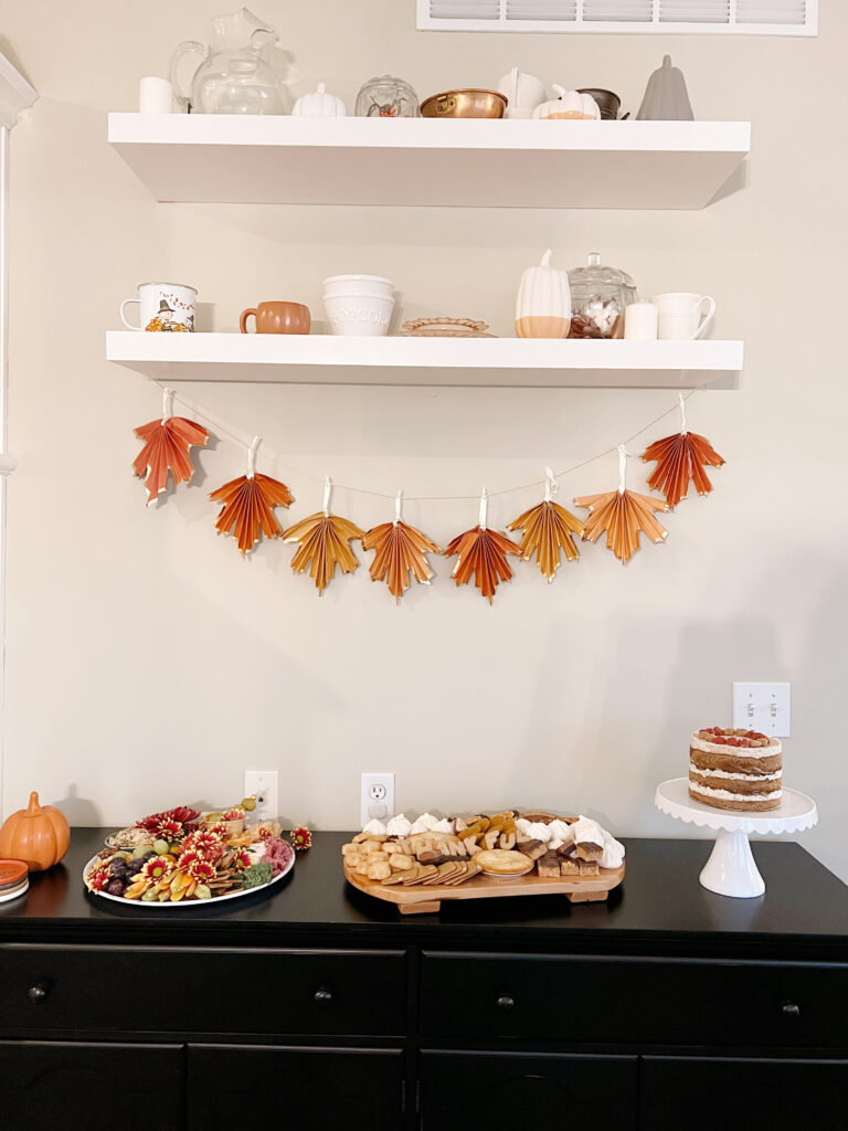 fall decorations and desserts on a buffet. 
