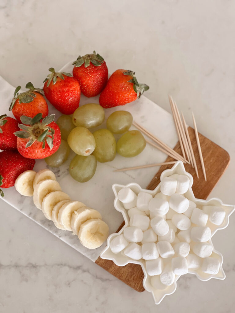 mini marshmallows and fruit on a tray.