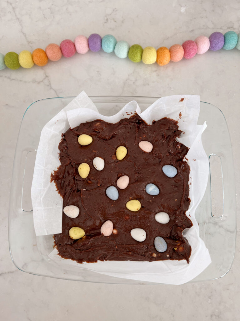 brownies in a pan topped with Cadbury eggs.
