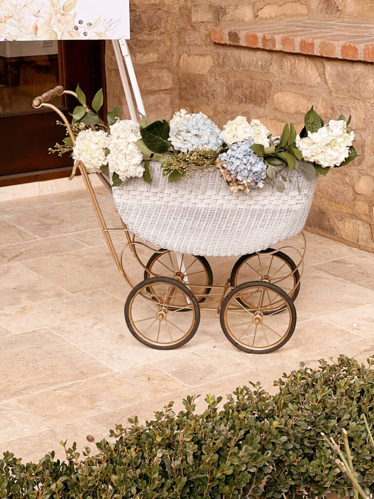 baby buggy with flowers inside. 