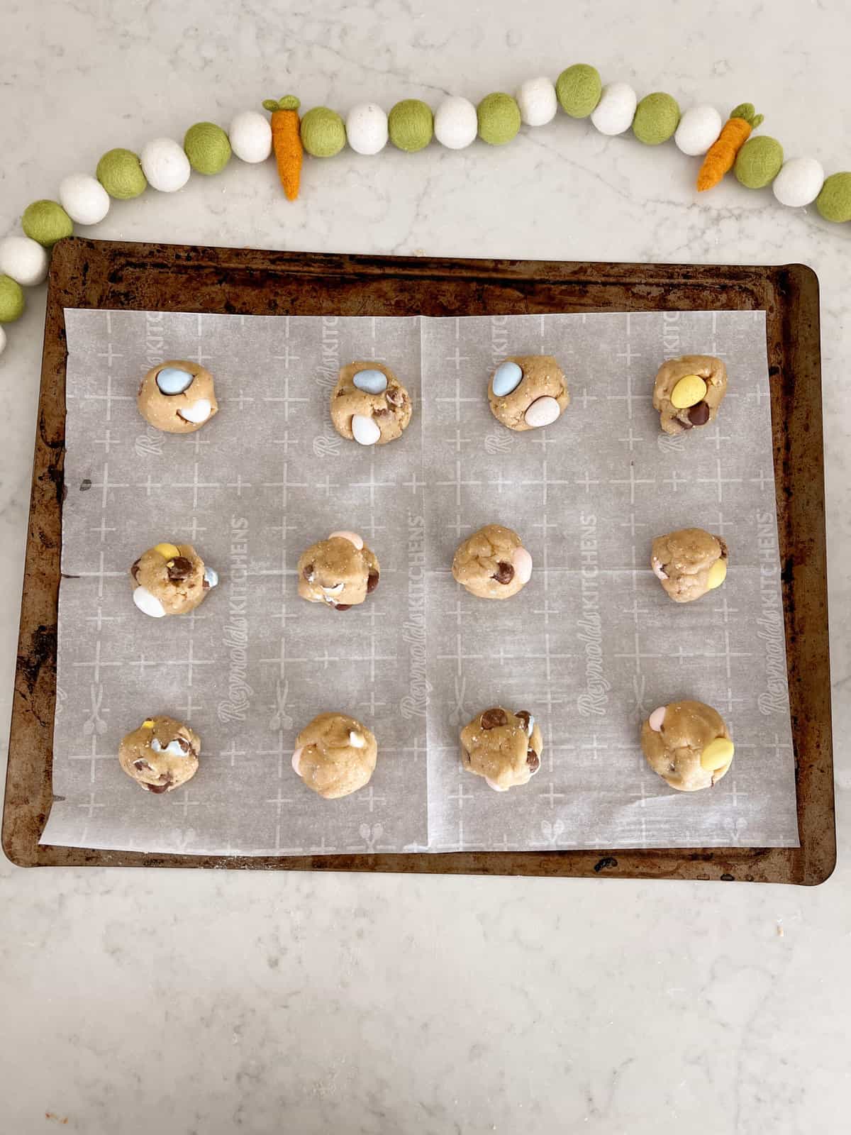 balled cookie dough on baking sheet. 