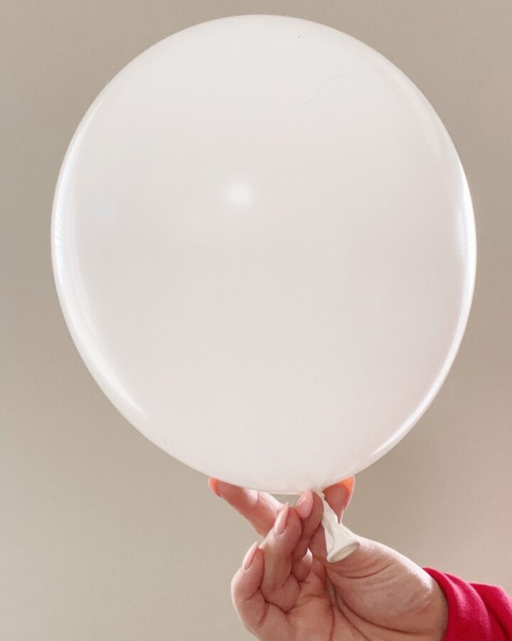 white balloon being held up.