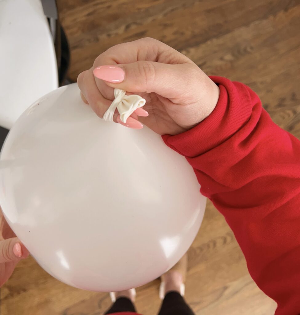 tying balloon to retain air.