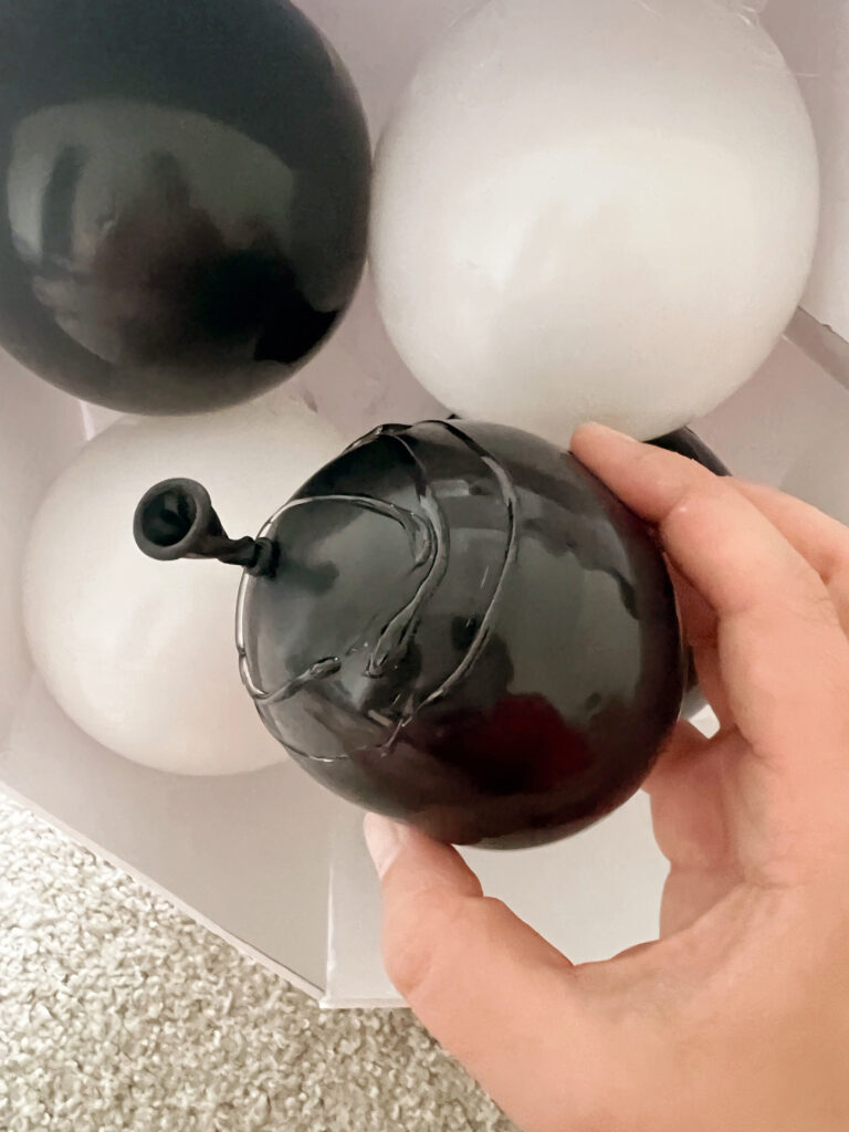 Small black balloon with hot glue on it. 