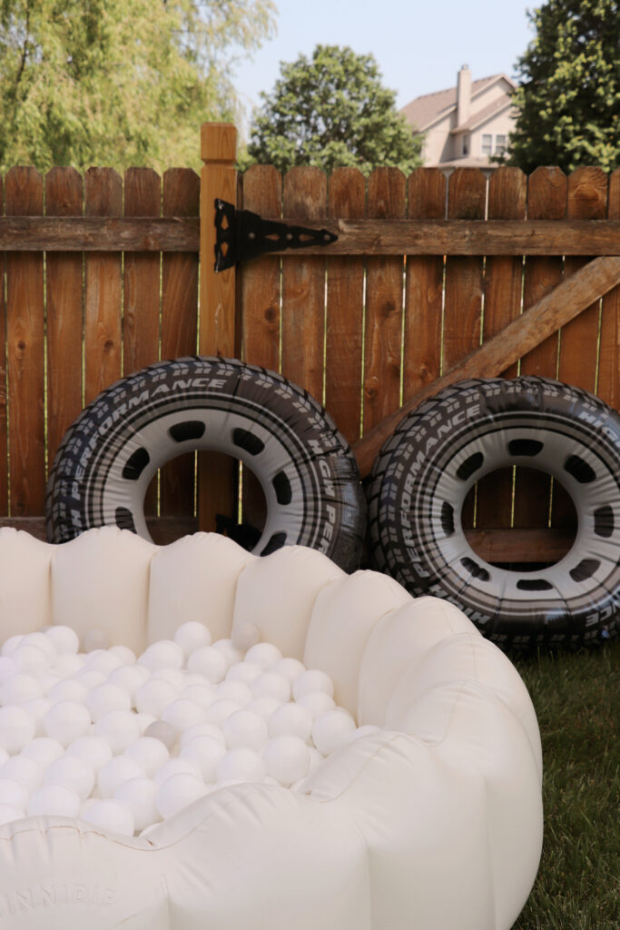 pool floaties that look like tires next to a ball pit .