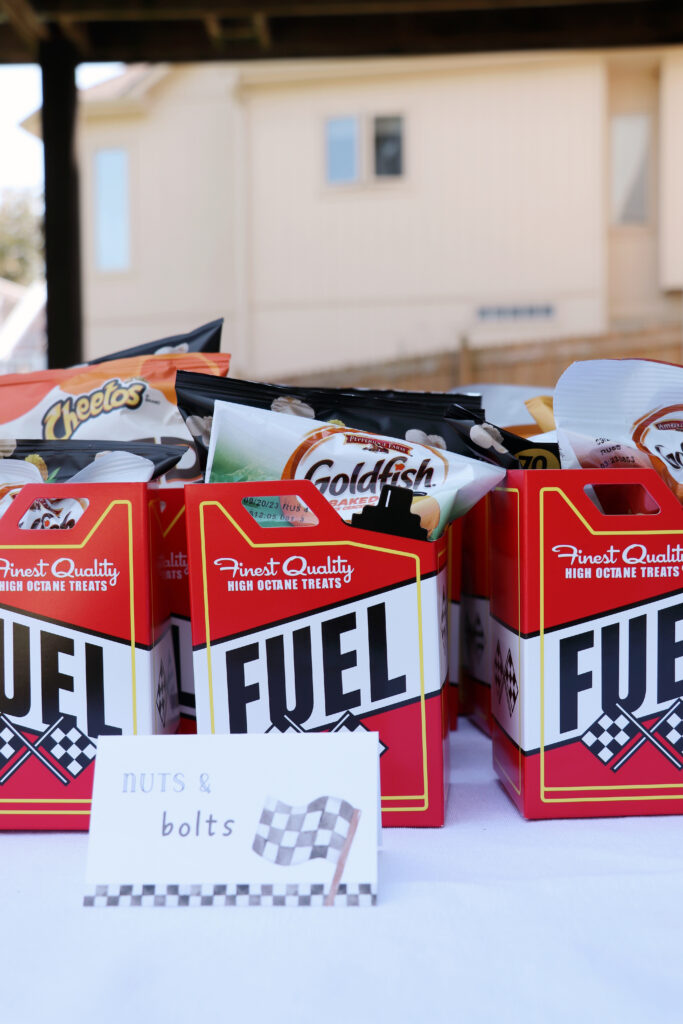 favor boxes shaped as fuel cans with goldfish and chips inside. 