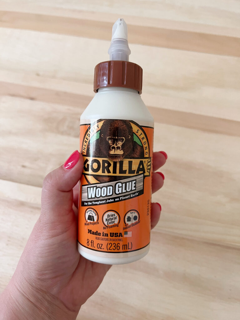 hand holding gorilla wood glue. 