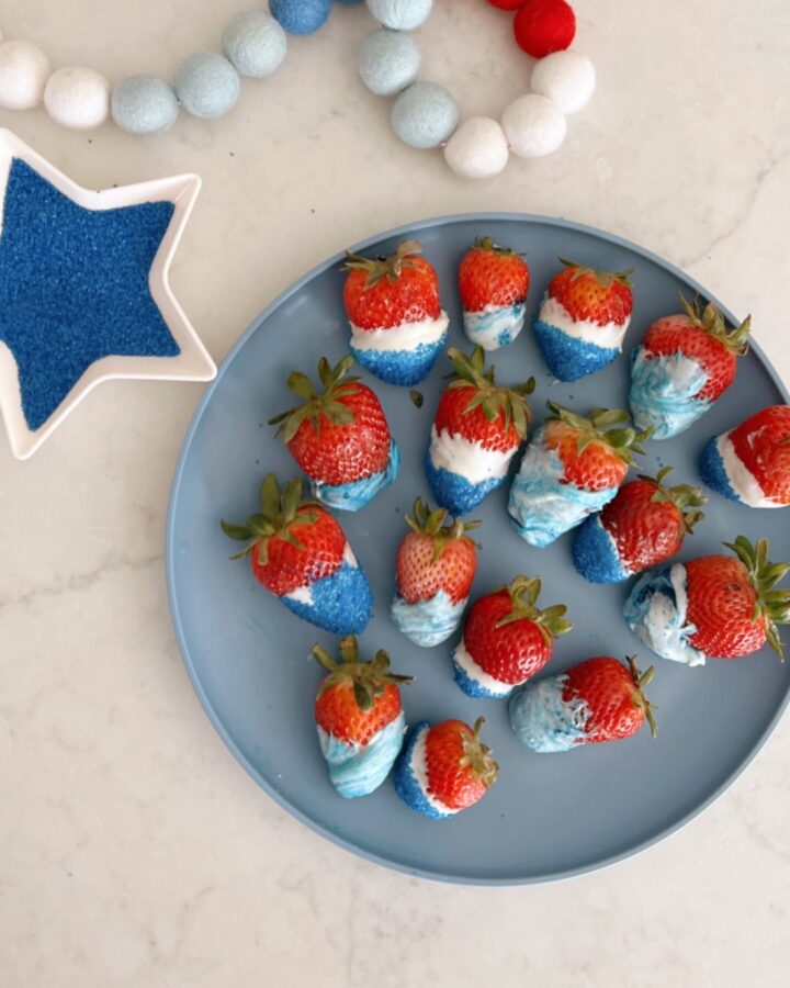strawberries dipped in white chocolate with blue swirls or sprinkles added.