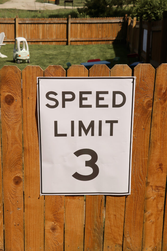 a speed limit sign on a fence. 