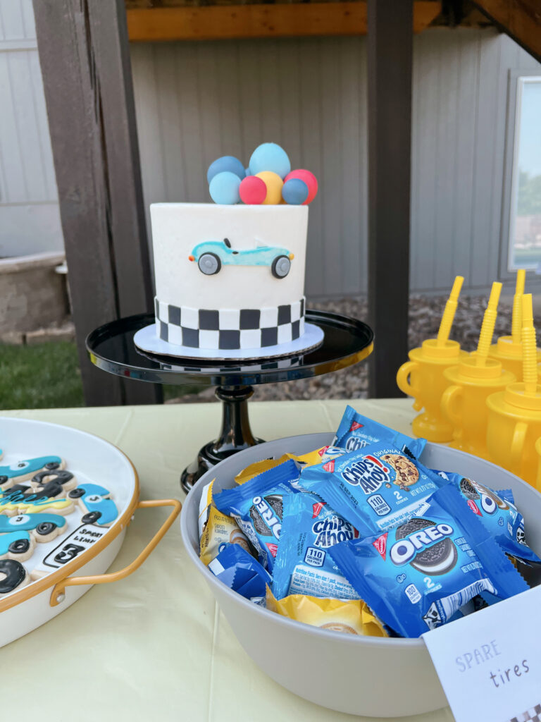 Race car themed cake and cookies. 