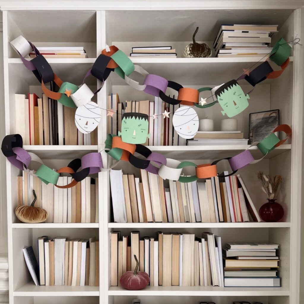 Paper chain decorations strung on a bookcase. 