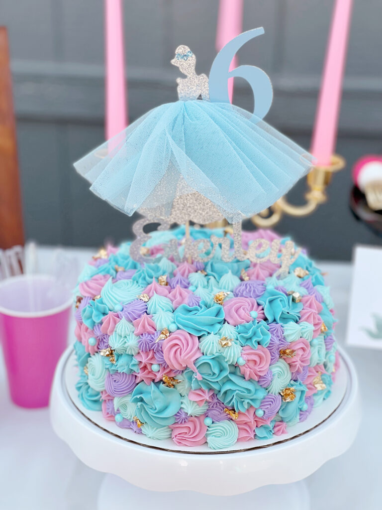 Decorated cake with a Cinderella topper.