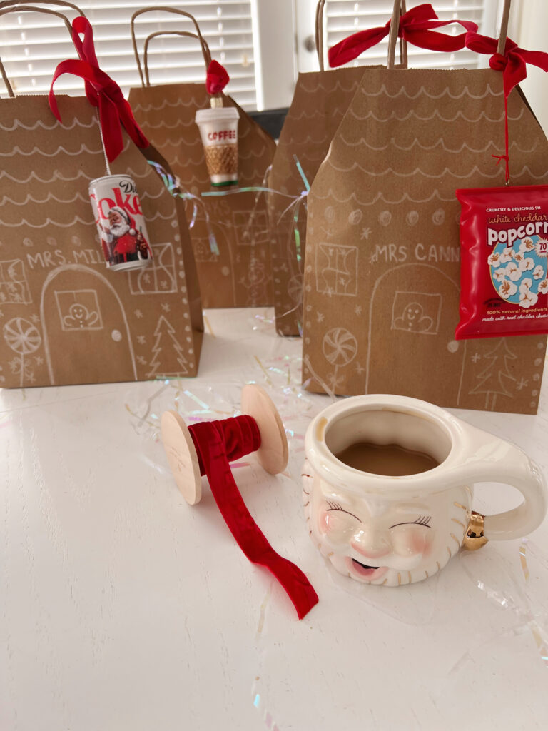 brown paper bags decorated as gingerbread houses and a cup a coffee.