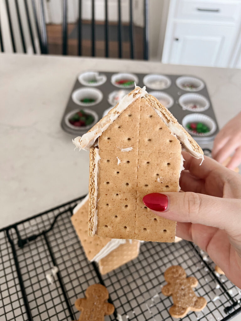 Assembled graham crackers to make a house shape. 