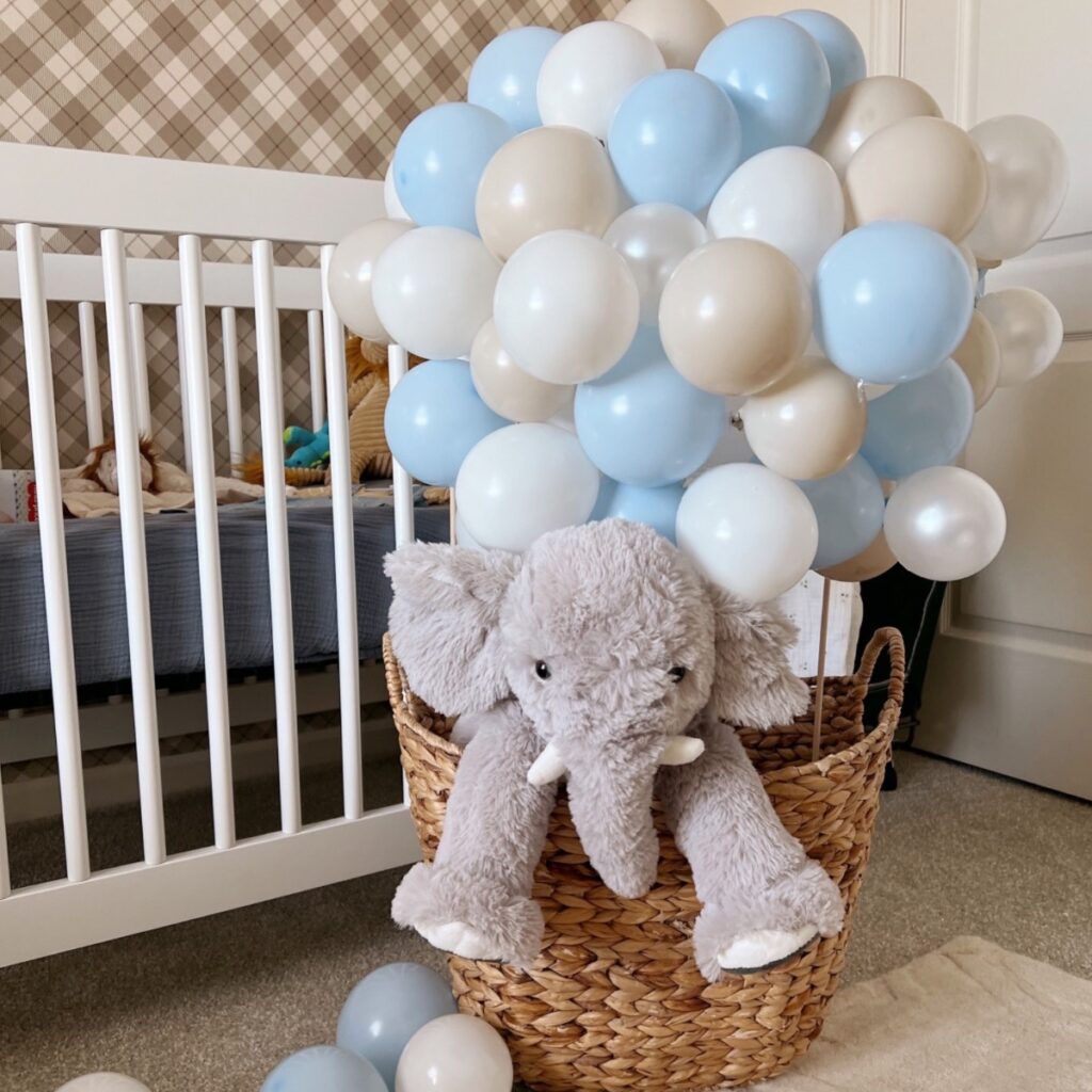 stuffed elephant in a basket made to look like a hot air balloon.