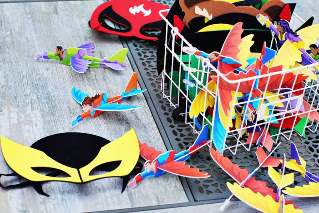 Superhero masks and paper planes as party favors.