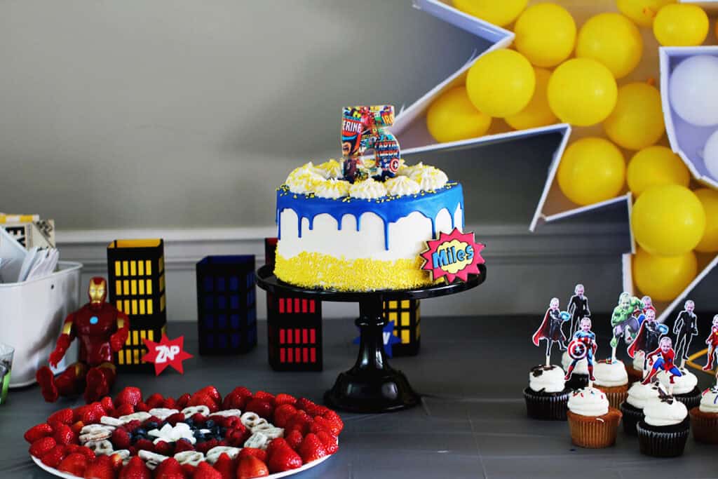 Yellow, white and blue super hero themed birthday cake.