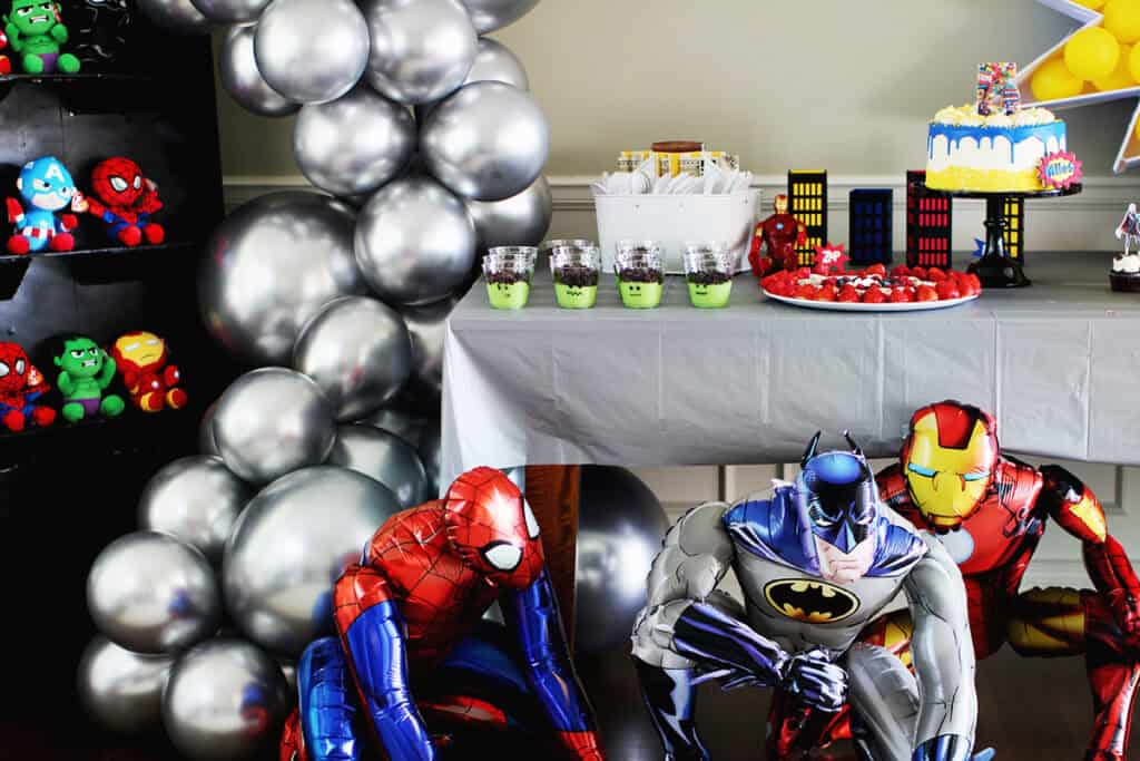 Superhero themed party decorations and balloons.