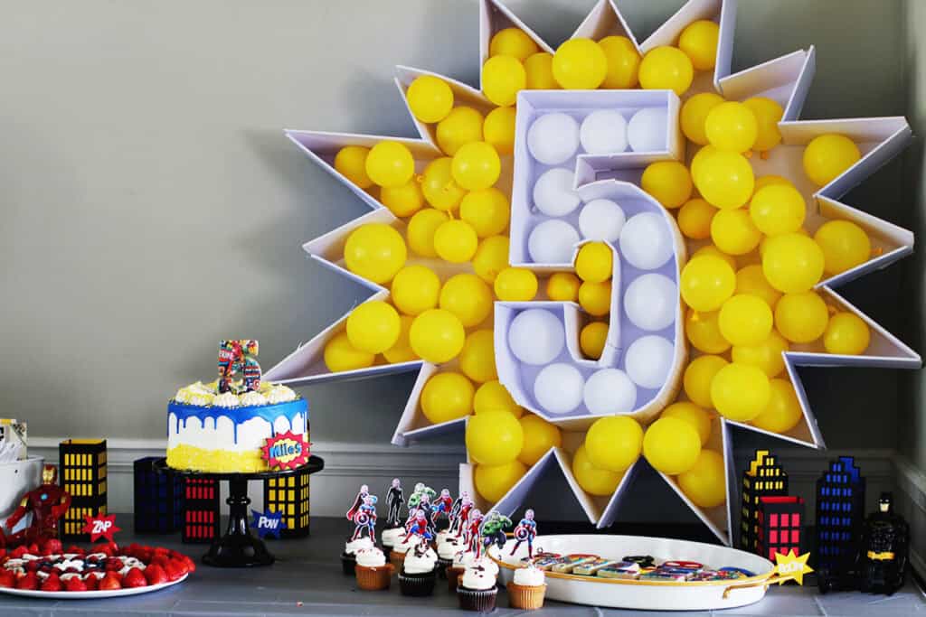 Number 5 balloon mosaic with yellow and white balloons.