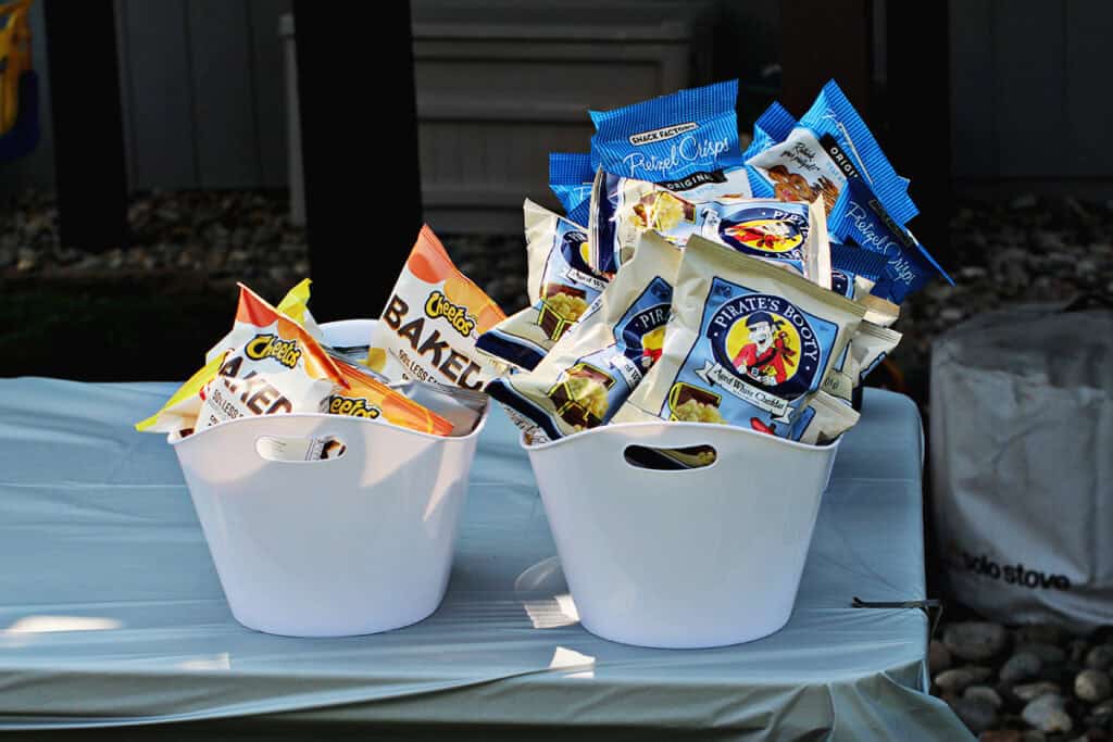 buckets holding chips and snacks for a birthday party.