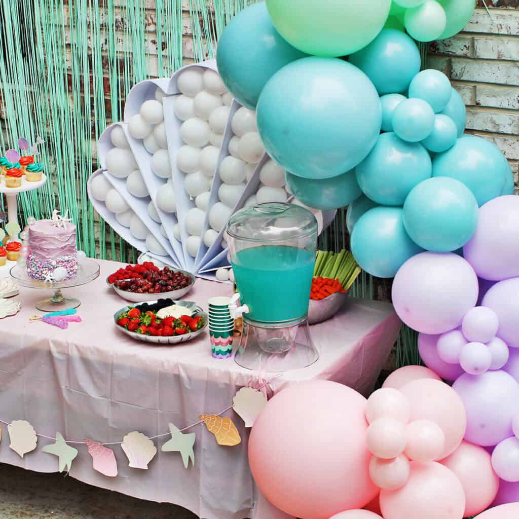 Party table for mermaid themed birthday party.