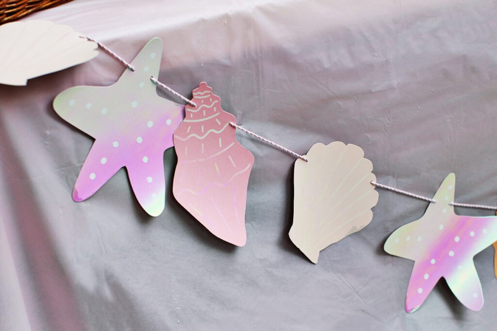 Mermaid themed garland on party table.